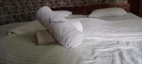a wrapped up limb sitting on top of a bed at selfia guest house majorda in Majorda