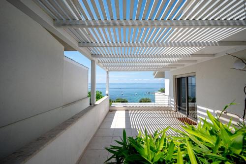a view of the ocean from the balcony of a house at Akti Elia Villas Beachfront Chalkidiki in Elia
