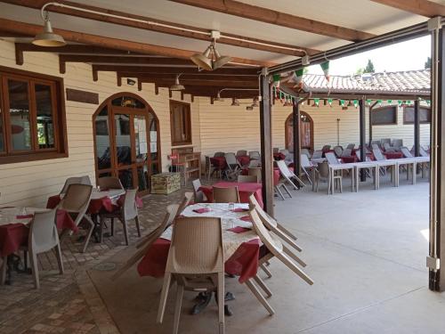a dining room with tables and chairs in a building at Mobile home Comfort Viareggio - Camping Paradiso- R028 in Viareggio