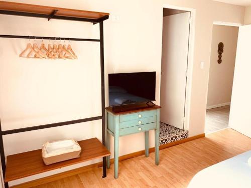 a bedroom with a bed with a desk and a television at Casa Porta in Lima