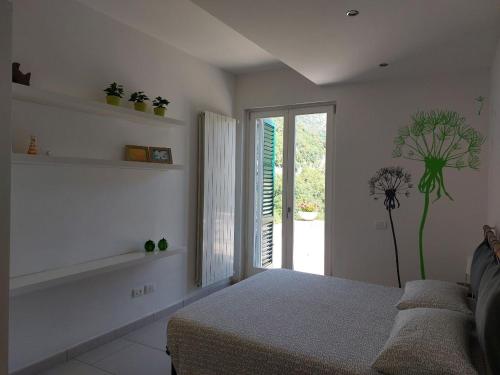 a bedroom with a bed and a window with a plant at Adagio Ravello in Ravello