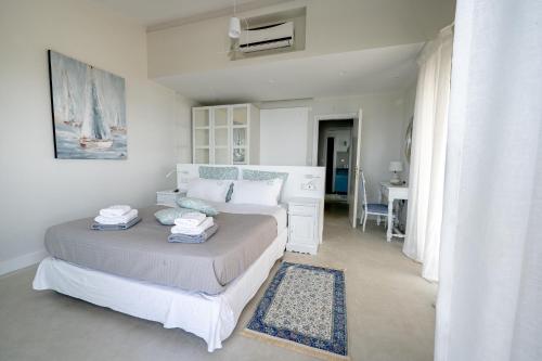 a bedroom with a bed and a desk in it at Akti Elia Villas Beachfront Chalkidiki in Elia