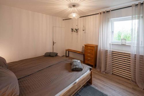 a bedroom with a large bed and a window at Ferienwohnung Rhön (Er) Leben in Sondheim