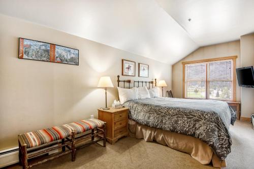 a bedroom with a large bed and a window at Copper Springs in Copper Mountain