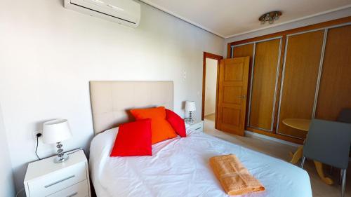 1 dormitorio con 1 cama con almohadas de color naranja y rojo en Penthouse Anchoa-A Murcia Holiday Rentals Property, en Roldán