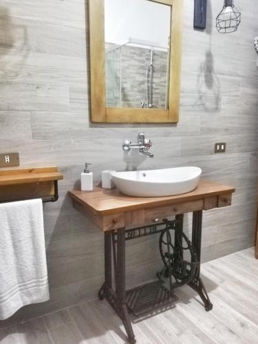 a bathroom with a sink and a mirror at Casa vacanza Flora in Grottazzolina