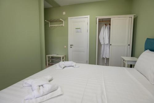 a bedroom with two towels on a bed at Buxus Hotel Shekvetili in Shekhvetili