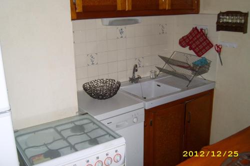 une petite cuisine avec un évier et une cuisinière dans l'établissement Chalet 