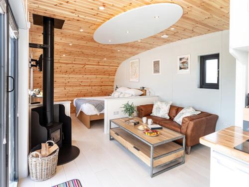 a living room with a couch and a fireplace at Low Longlands in Cartmel