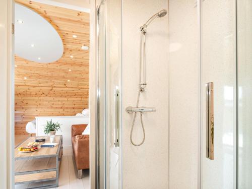 a shower with a glass door in a bathroom at Low Longlands in Cartmel