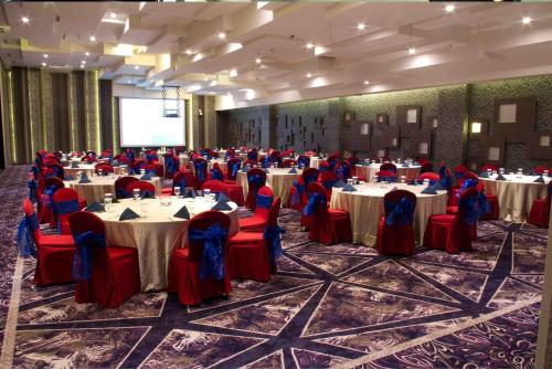 a banquet hall with tables and chairs in a room at Holiday Inn Cikarang Jababeka by IHG in Cikarang