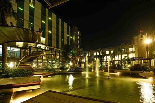 a large building with a courtyard at night at Holiday Inn Cikarang Jababeka by IHG in Cikarang