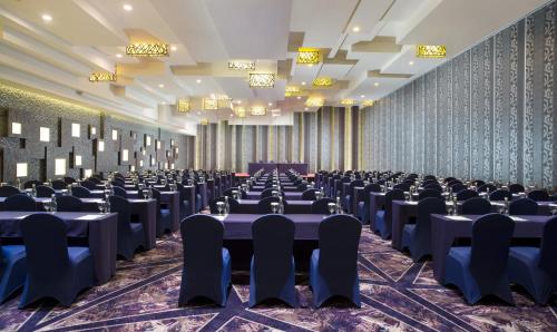 a large room with tables and chairs in it at Holiday Inn Cikarang Jababeka by IHG in Cikarang