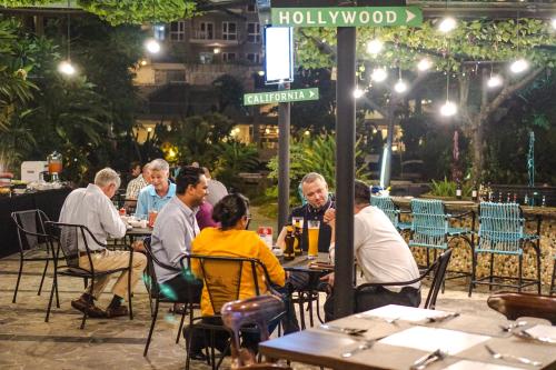 a group of people sitting at tables at an outdoor restaurant at Holiday Inn Cikarang Jababeka by IHG in Cikarang