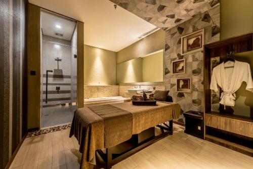 a bathroom with a sink and a shower and a table at Holiday Inn Cikarang Jababeka by IHG in Cikarang