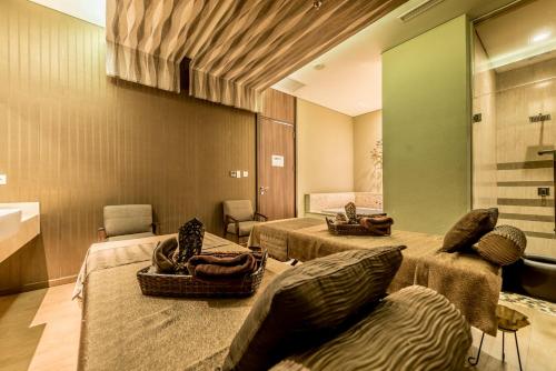 a room with three beds in a room at Holiday Inn Cikarang Jababeka by IHG in Cikarang