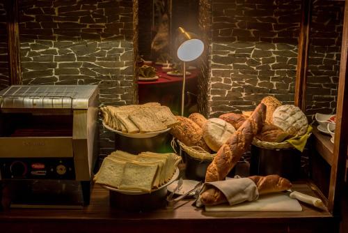 a table with baskets of bread and a microwave at Holiday Inn Cikarang Jababeka by IHG in Cikarang