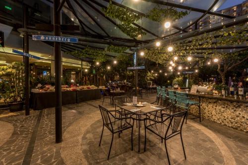 a restaurant with tables and chairs in a building at Holiday Inn Cikarang Jababeka by IHG in Cikarang