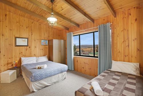 a bedroom with two beds and a large window at Providence Park in Providence Portal