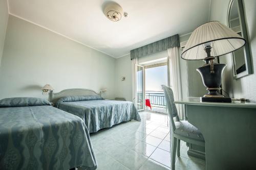 Postel nebo postele na pokoji v ubytování Hotel Murano