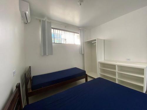 a small room with a bed and a window at Condominio Boa Vista in Pontal do Paraná