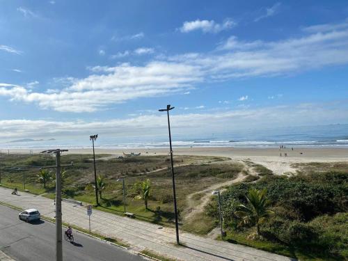 a street light next to a beach with people at Condominio Boa Vista in Pontal do Paraná