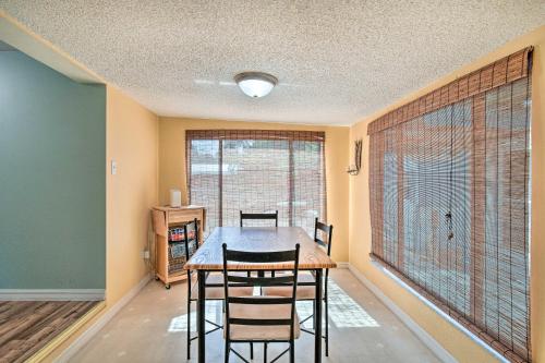 a dining room with a table and chairs and a large window at Peaceful Satsuma Escape with Dunns Creek Access in Satsuma
