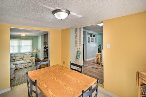 a dining room with a table and a living room at Peaceful Satsuma Escape with Dunns Creek Access in Satsuma