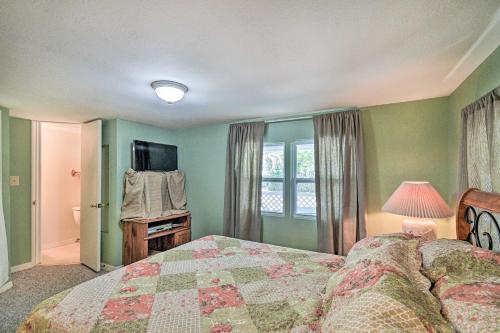 a bedroom with a bed and a television in it at Peaceful Satsuma Escape with Dunns Creek Access in Satsuma