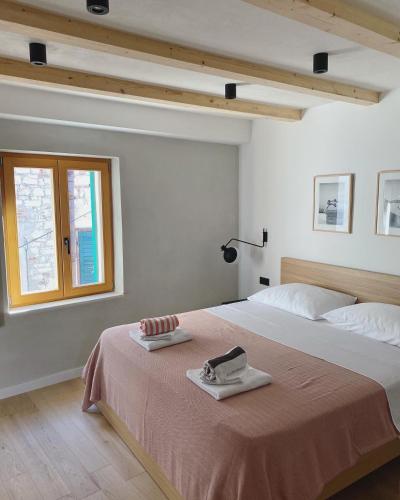 a bedroom with a bed and a window at Ancient & Modern in Šibenik