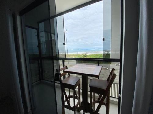 a table and chairs on a balcony with a view at Condominio Boa Vista in Pontal do Paraná