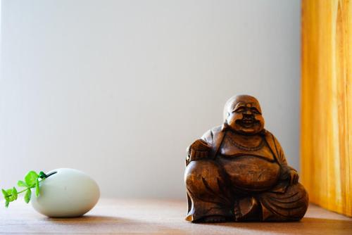 a wooden figurine sitting on a table next to a egg at Luxury Villa L'ile Maurice in Pointe aux Cannoniers