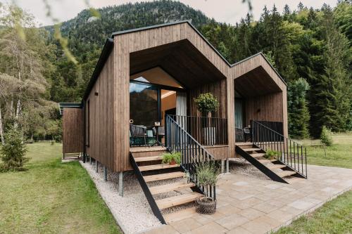 a small house with a staircase leading up to it at Naturhotel Schütterbad in Unken