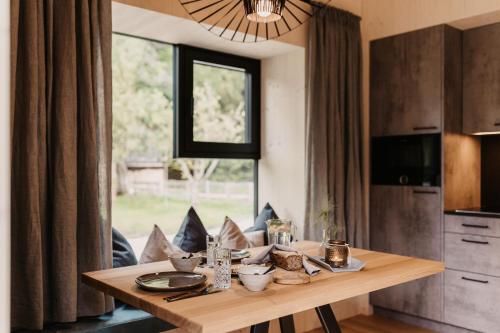 a dining table in a kitchen with a window at Naturhotel Schütterbad in Unken