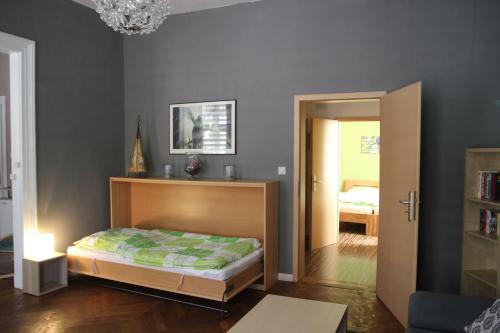 a bedroom with a bed and a chandelier at Ferienwohnung zum Eifgental in Wermelskirchen