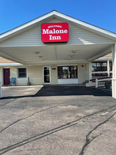 a store with a sign that reads malone inn at Malone Inn in Malone
