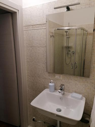 a bathroom with a sink and a mirror at IN CENTRO in Porto SantʼElpidio