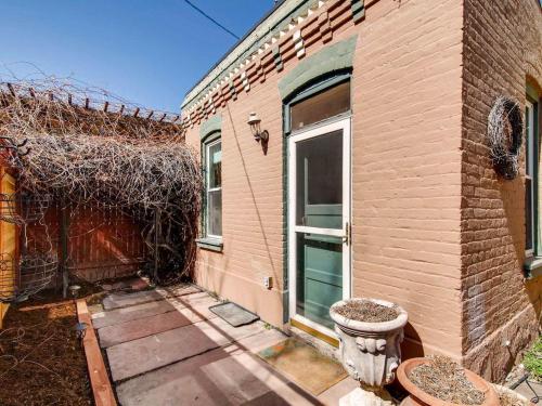 a brick house with a door on the side of it at 3329 W 31st in Denver