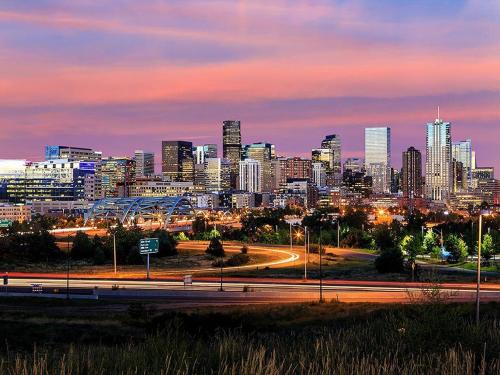 a city skyline at night with a highway in the foreground at 3329 W 31st in Denver