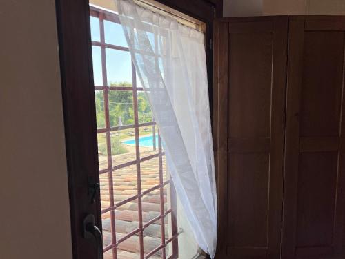 a door with a window with a view of a pool at Tenuta delle Acque in Acquasparta