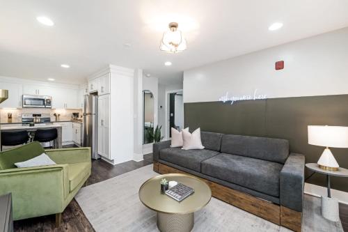 a living room with a couch and a table at Abode Nashville - Germantown in Nashville