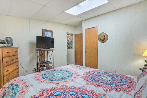 a bedroom with a bed and a flat screen tv at Waterfront Sparta Gem with Fire Pit and Kayak! in Sparta