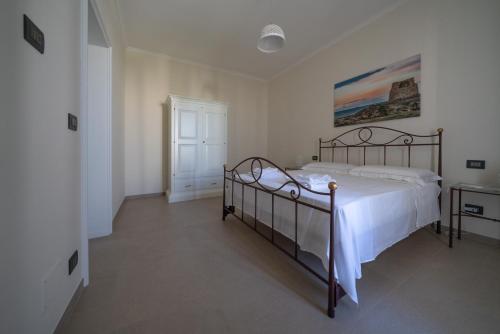 a bedroom with a large bed with white sheets at CasaRizzo in Torre dell'Orso