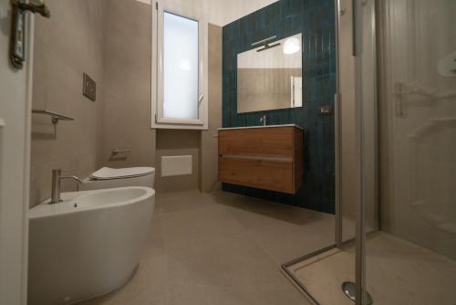 a bathroom with a tub and a sink and a shower at CasaRizzo in Torre dell'Orso