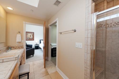 a bathroom with a walk in shower and a glass door at Mears House Unit 3C in Durango