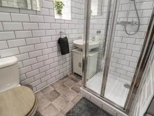 a bathroom with a shower and a toilet and a sink at 45 Prince Street in Keighley