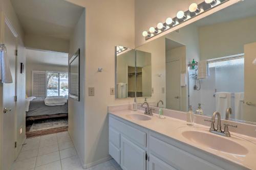 a bathroom with two sinks and a large mirror at Saddlebrooke Home with Private Pool and Amenities in Catalina