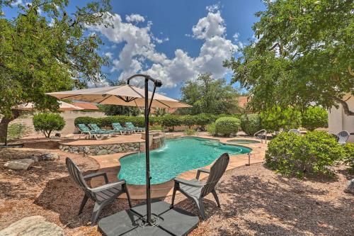 a swimming pool with two chairs and an umbrella at Saddlebrooke Home with Private Pool and Amenities in Catalina