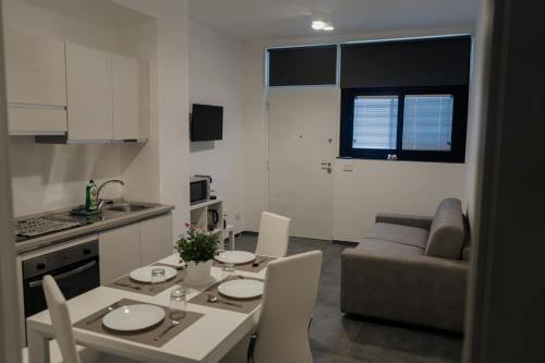 a kitchen and living room with a table and chairs at DOMUS RESIDENCE - CESARE - in Bari