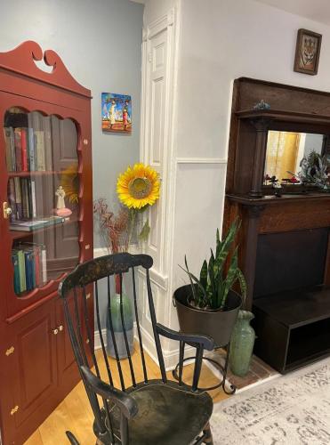 a rocking chair in a living room with a plant at Northern Liberties Retreat in Philadelphia